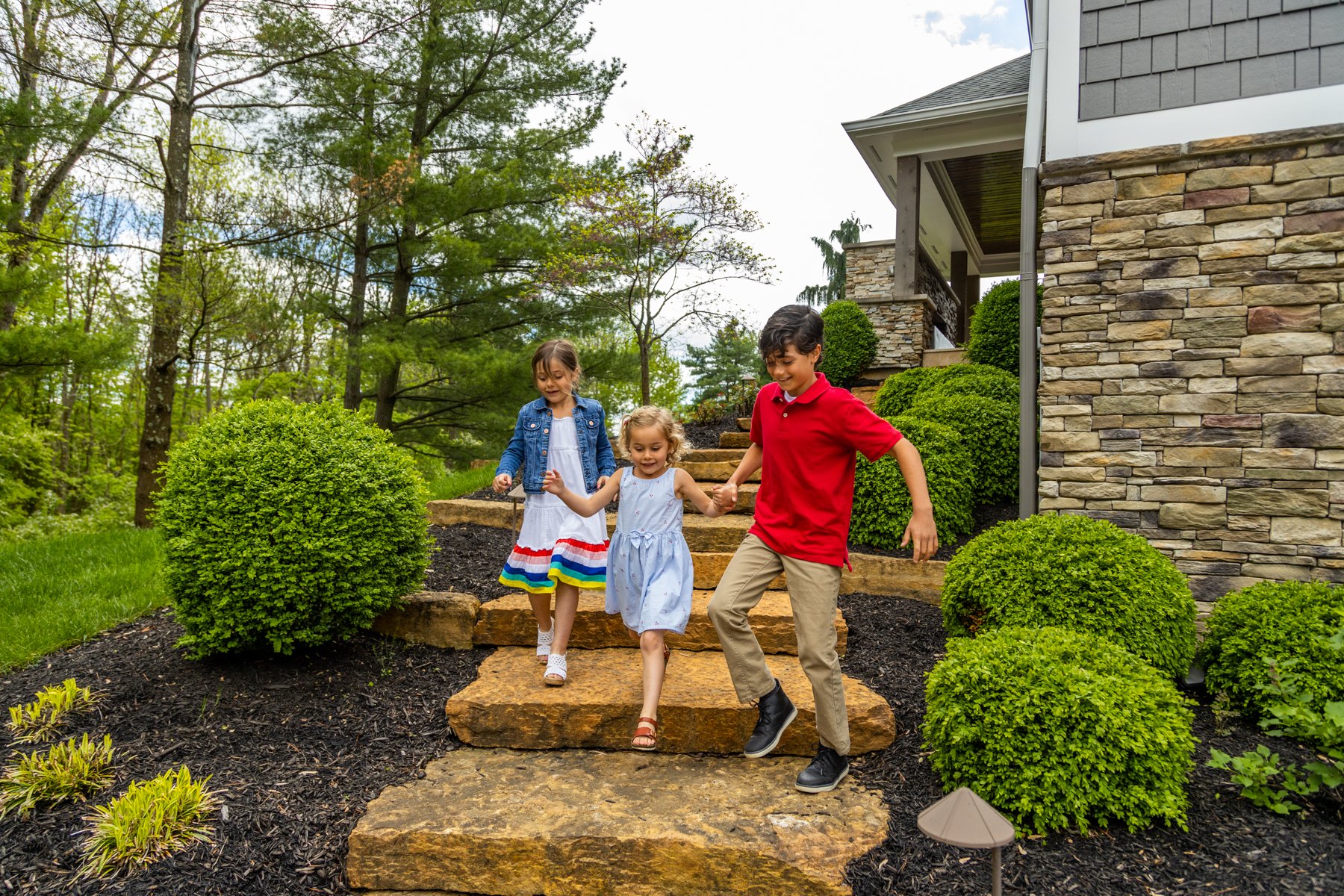 Oasis Turf & Tree - customer kids natural stone steps shrubs landscape lighting 2